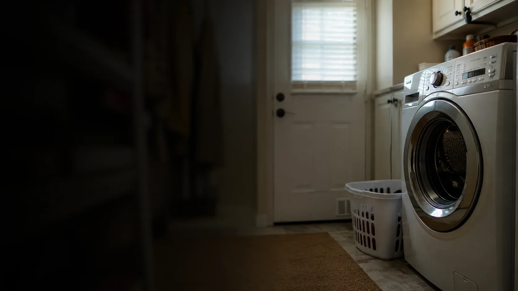 Technician repairing a washing machine in a Syracuse home